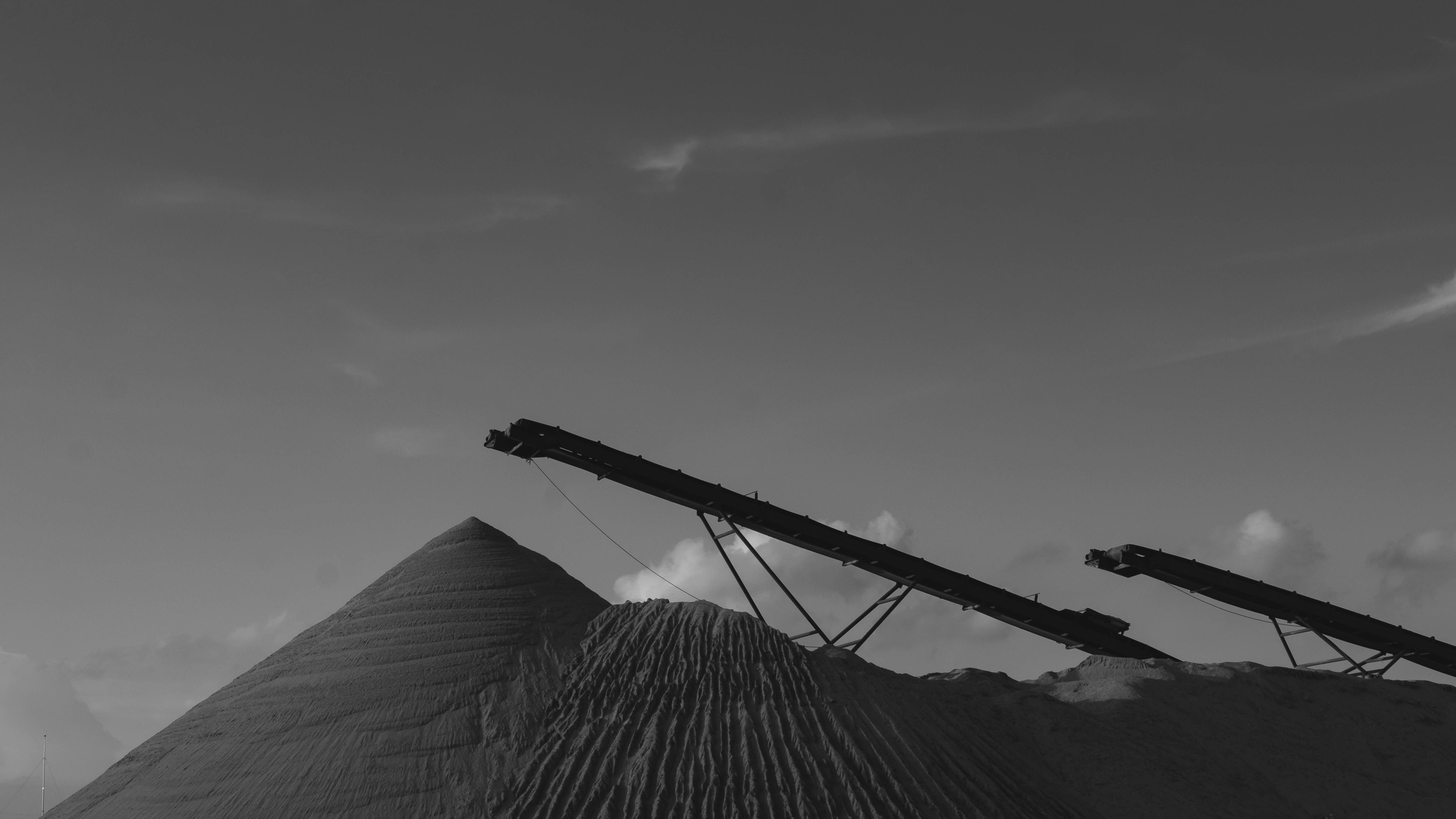 A black and white photo of a crane on top of a mountain photo – Free ...