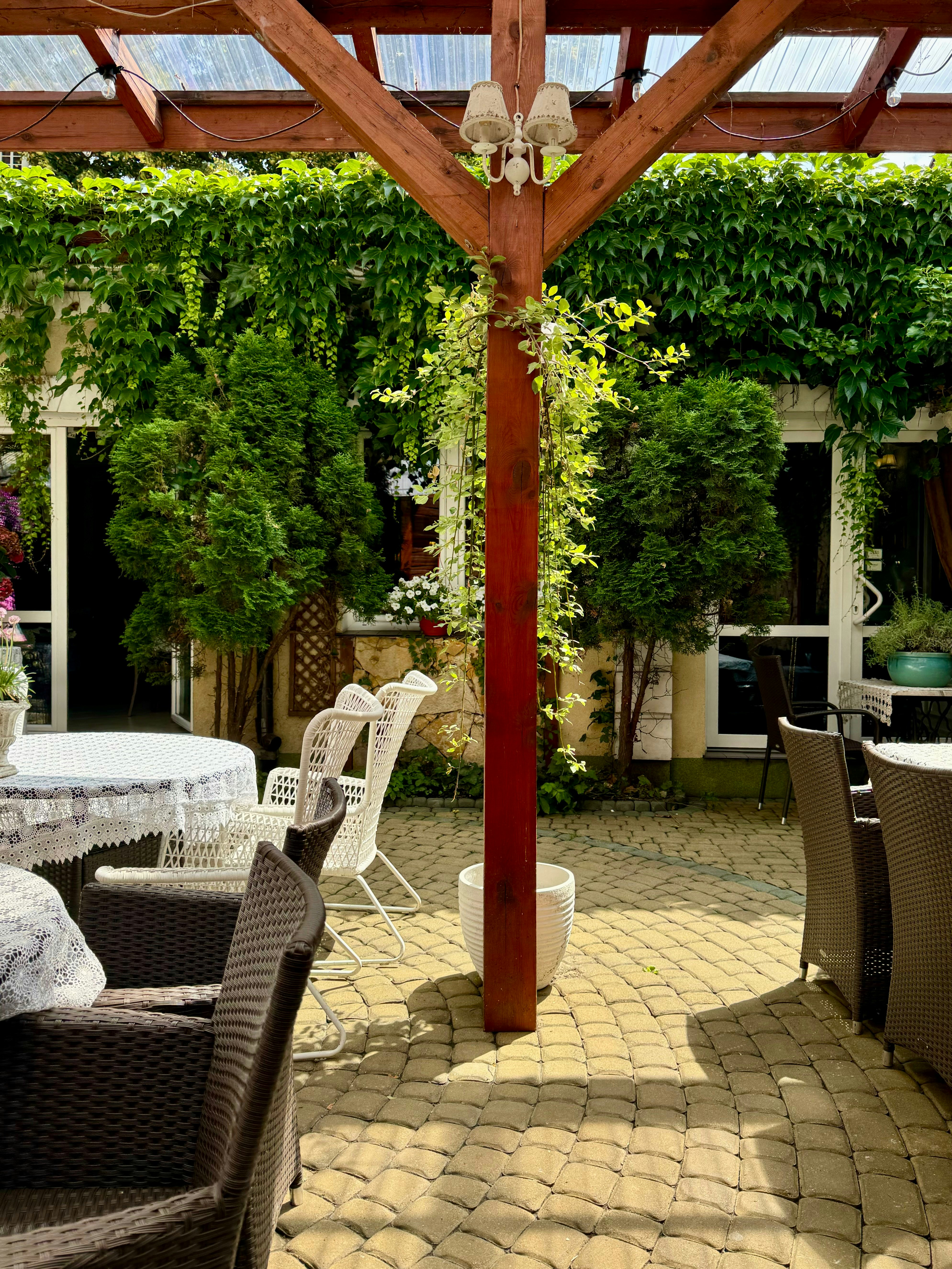 A patio with a table, chairs, and umbrella