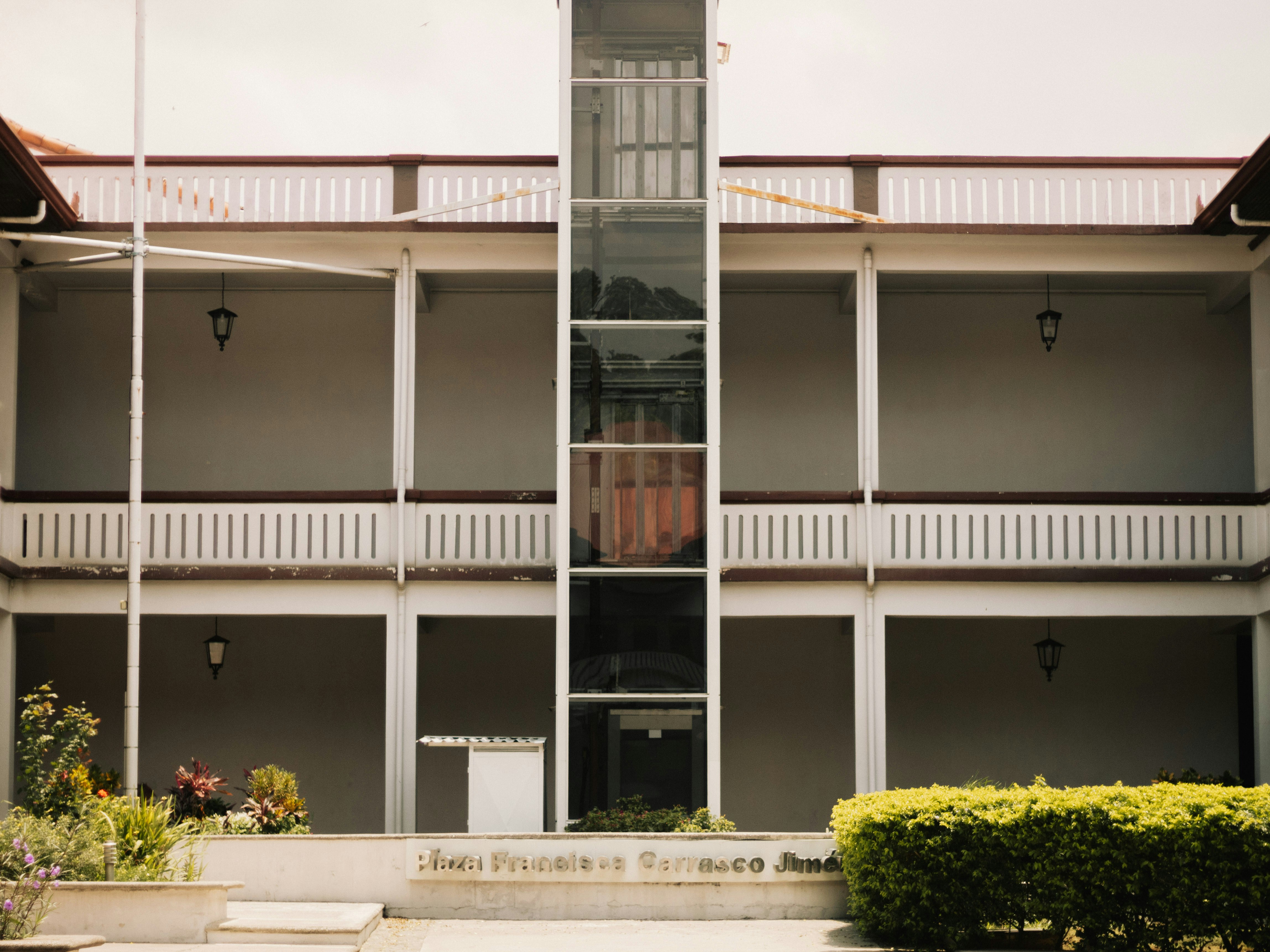 An apartment building with a clock tower in the middle of it