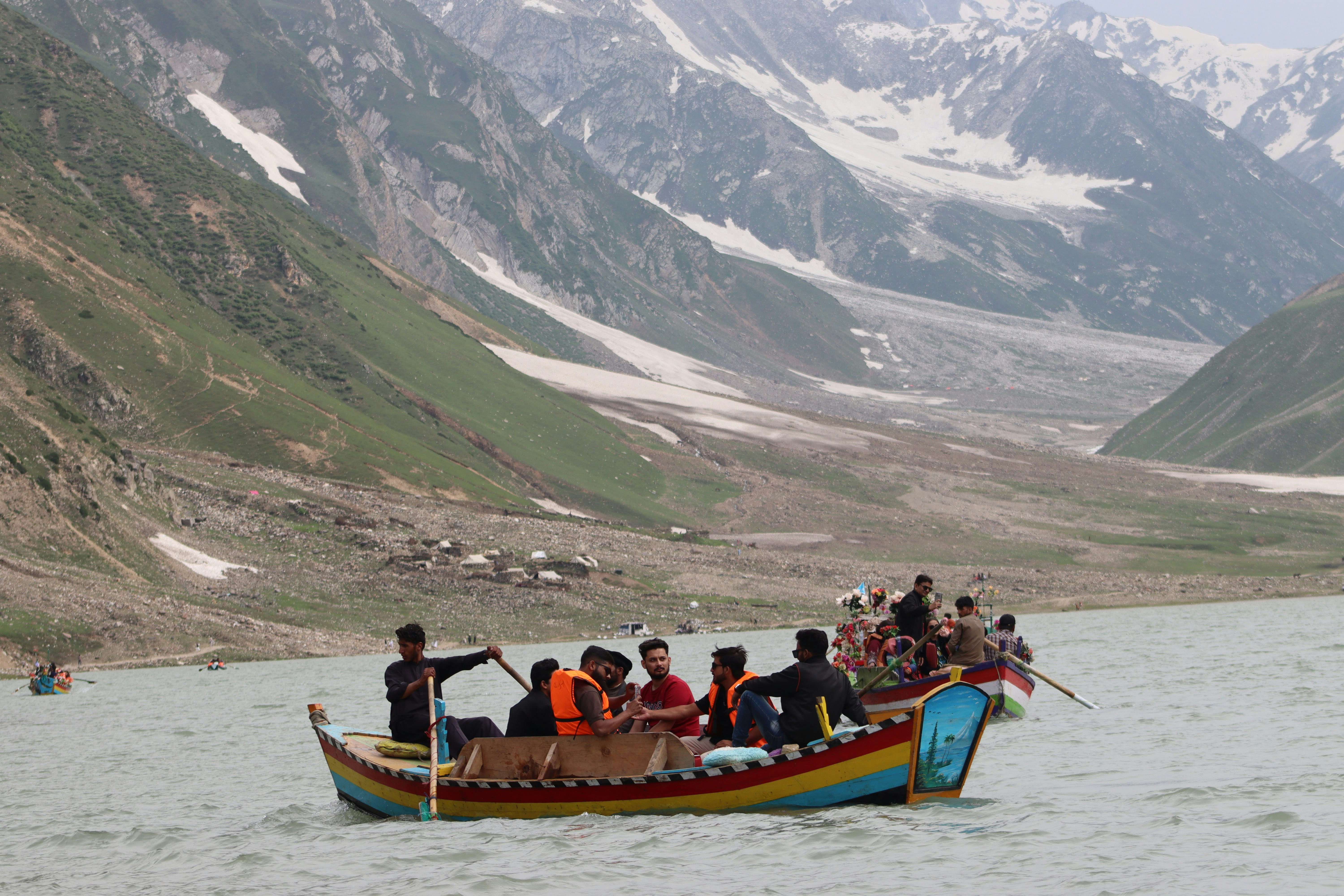 A group of people riding on the back of a boat