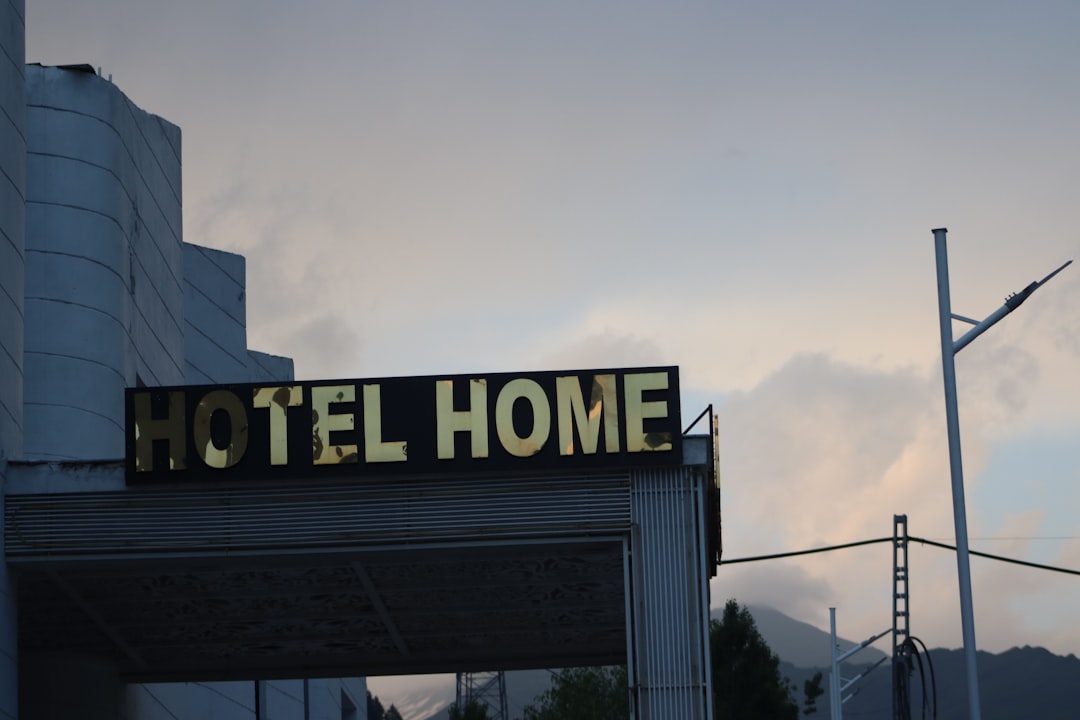 A sign that reads hotel home on the side of a building,
