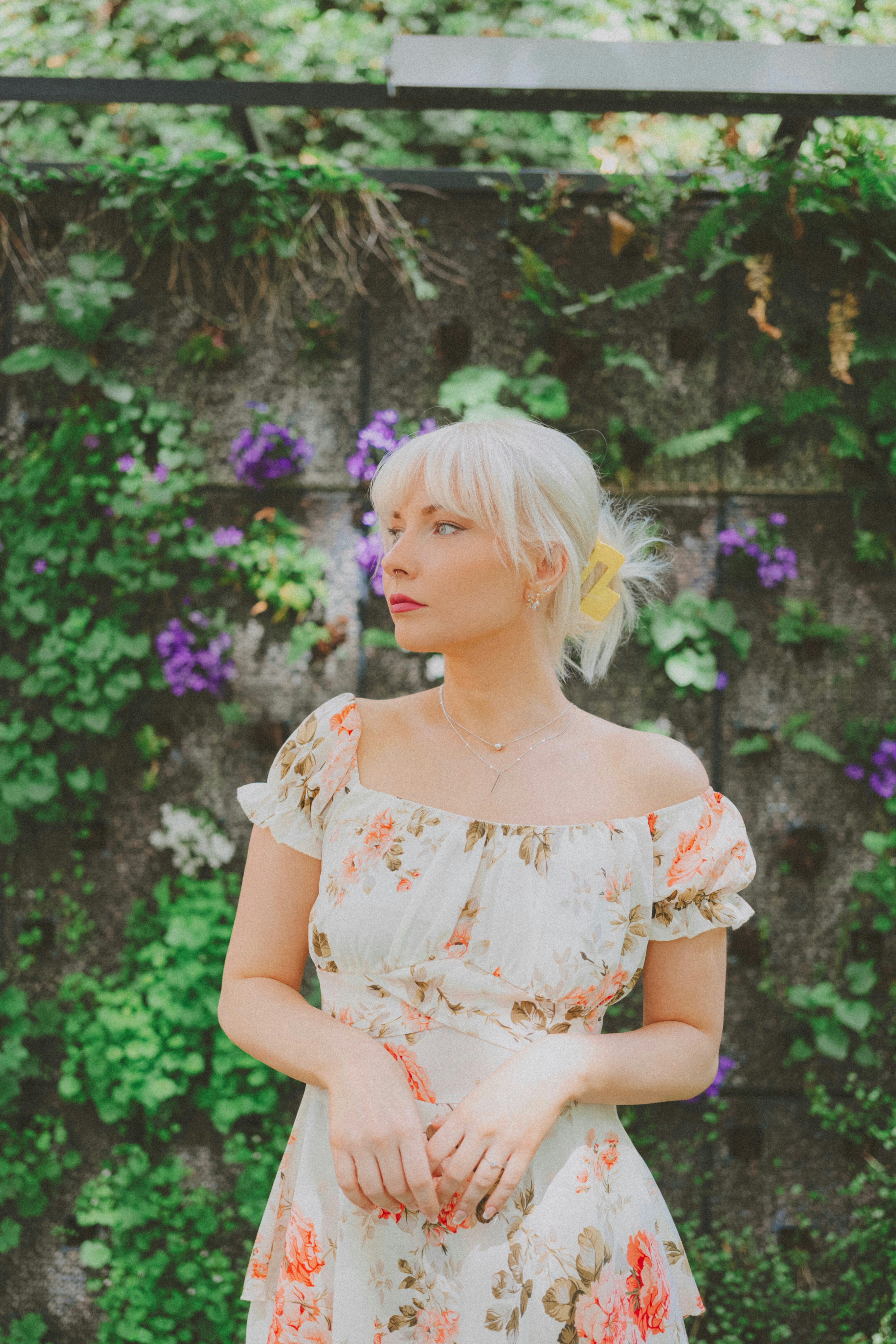 A woman standing in front of a green wall