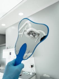 A person holding a toothbrush up to the camera