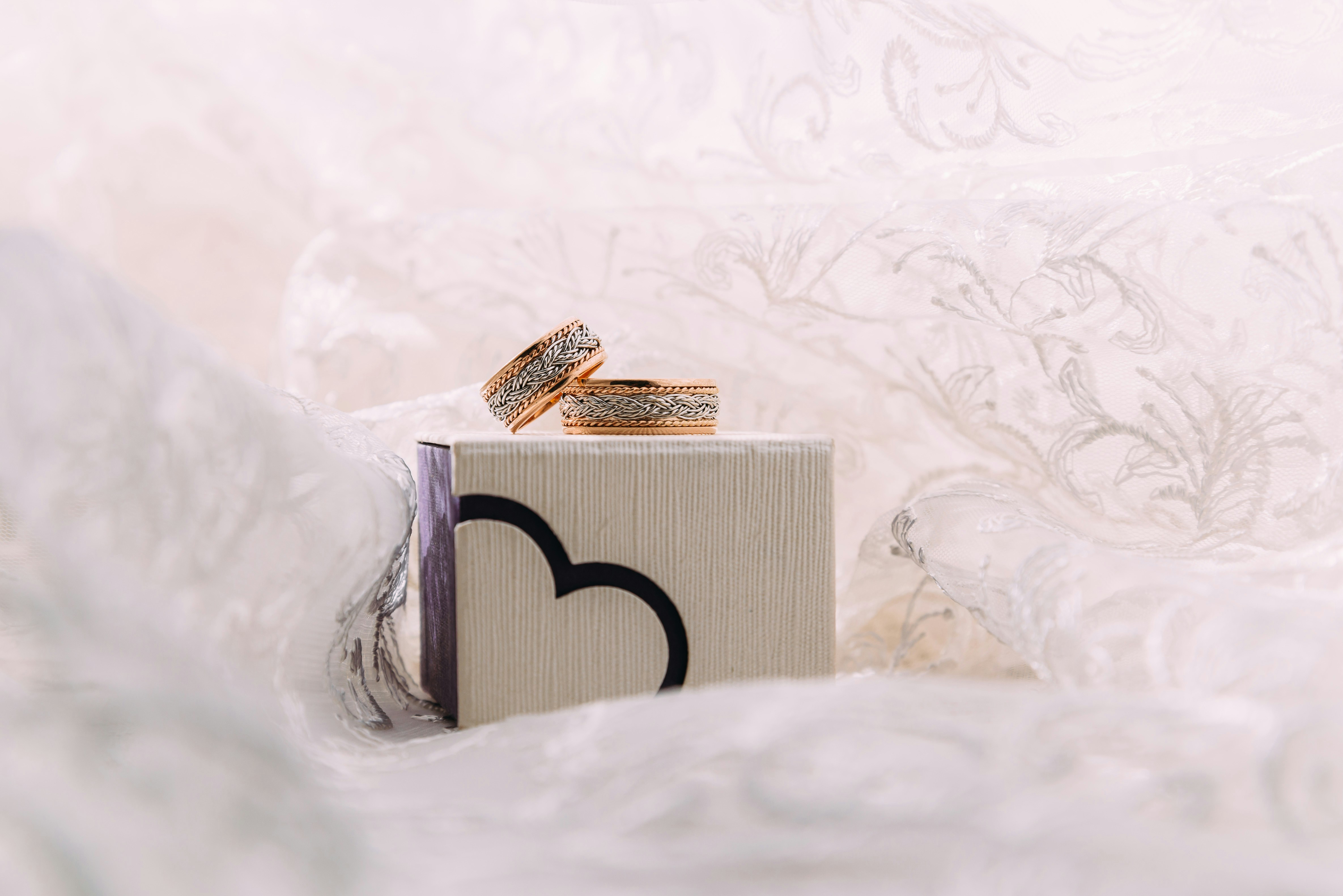 A couple of wedding rings sitting on top of a box