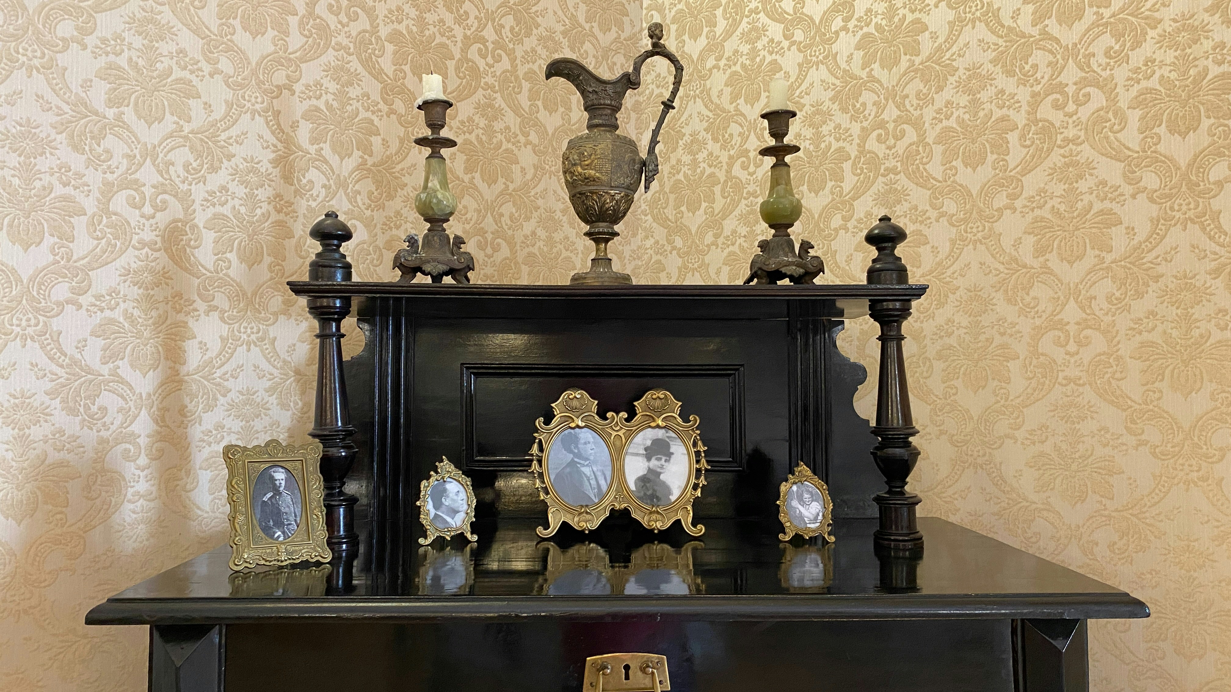 A black cabinet with a clock on top of it