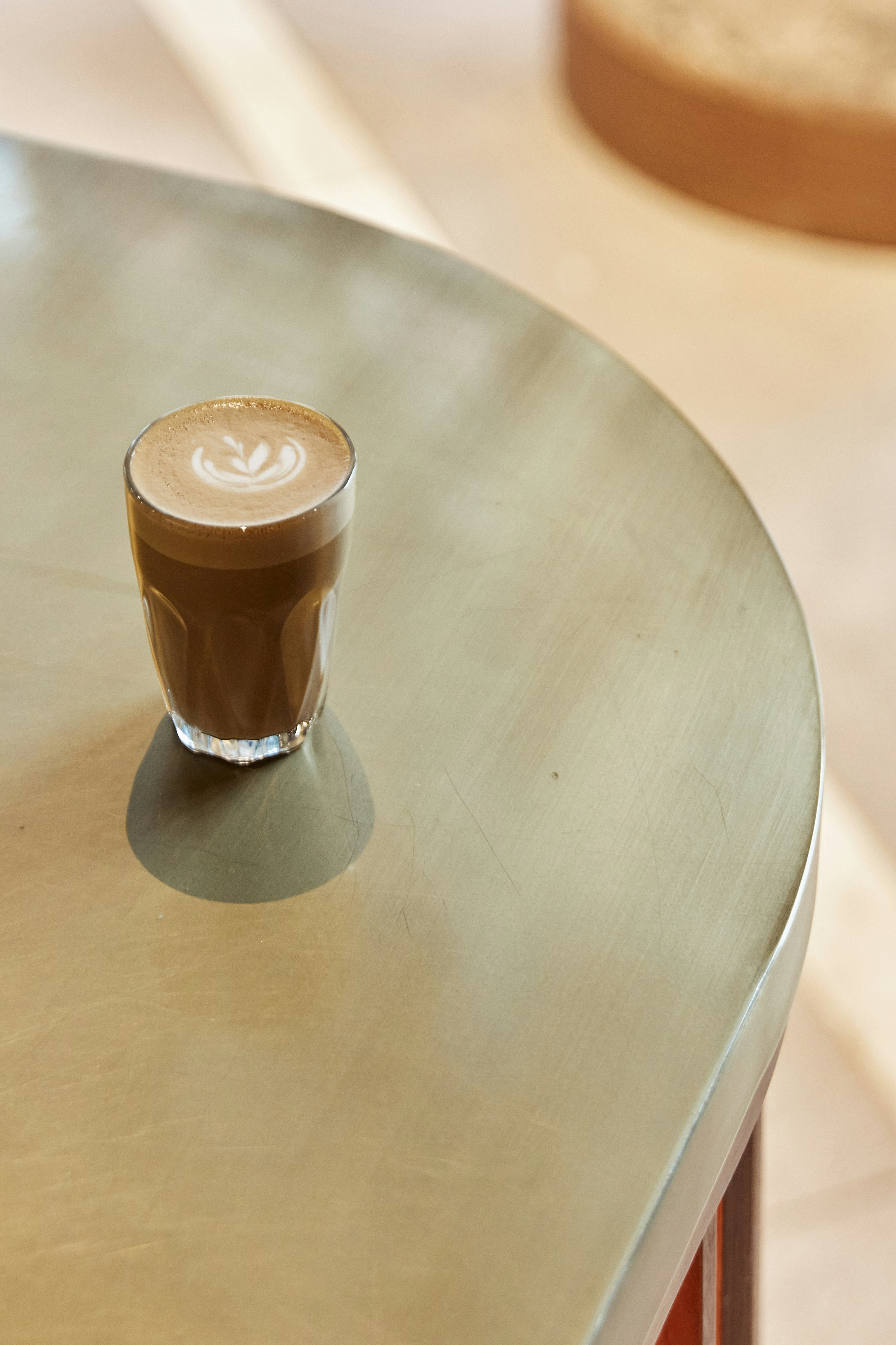 A cappuccino sitting on top of a metal table