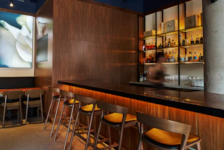 A bar with a bunch of stools in front of it