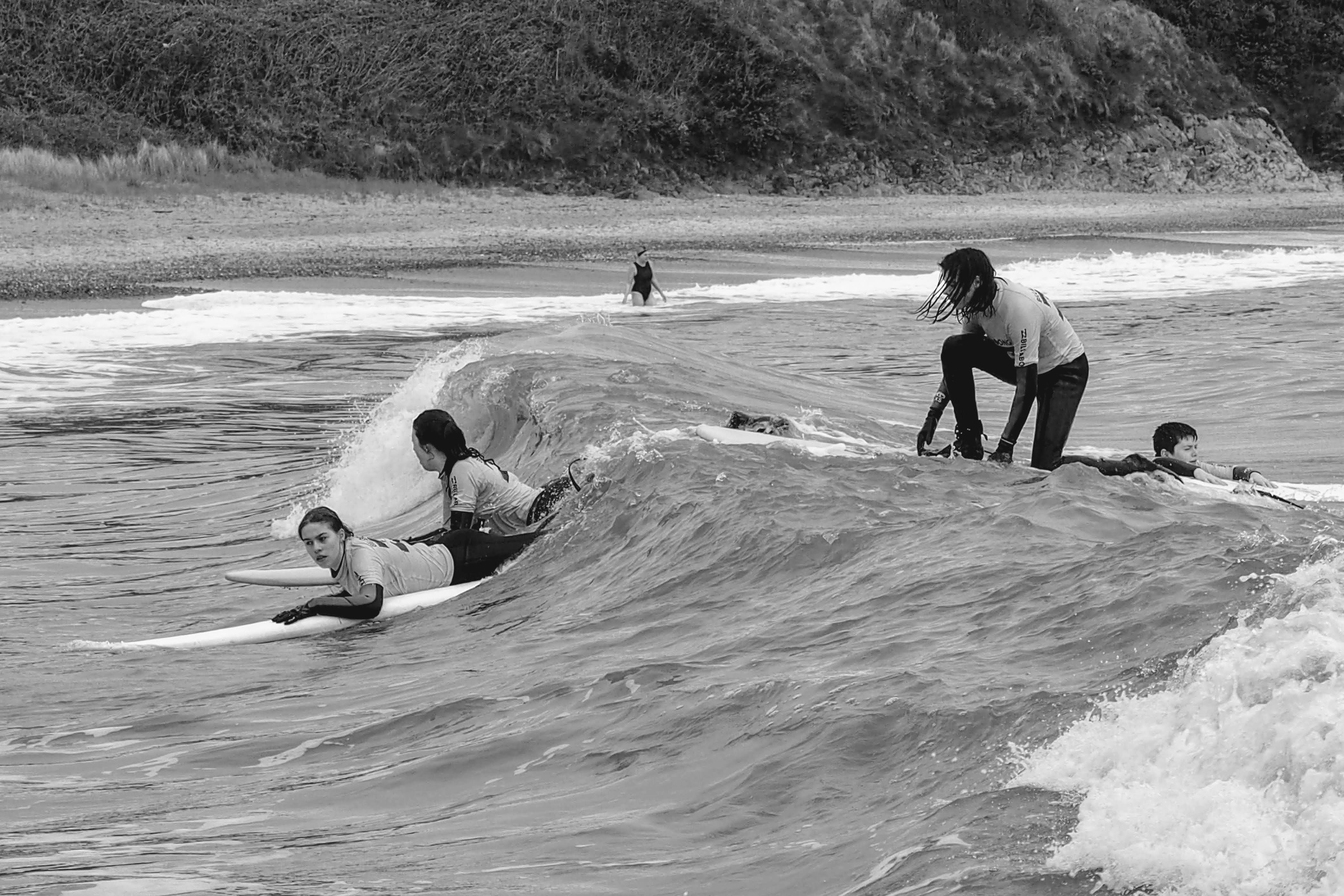 A man riding a wave on top of a surfboard