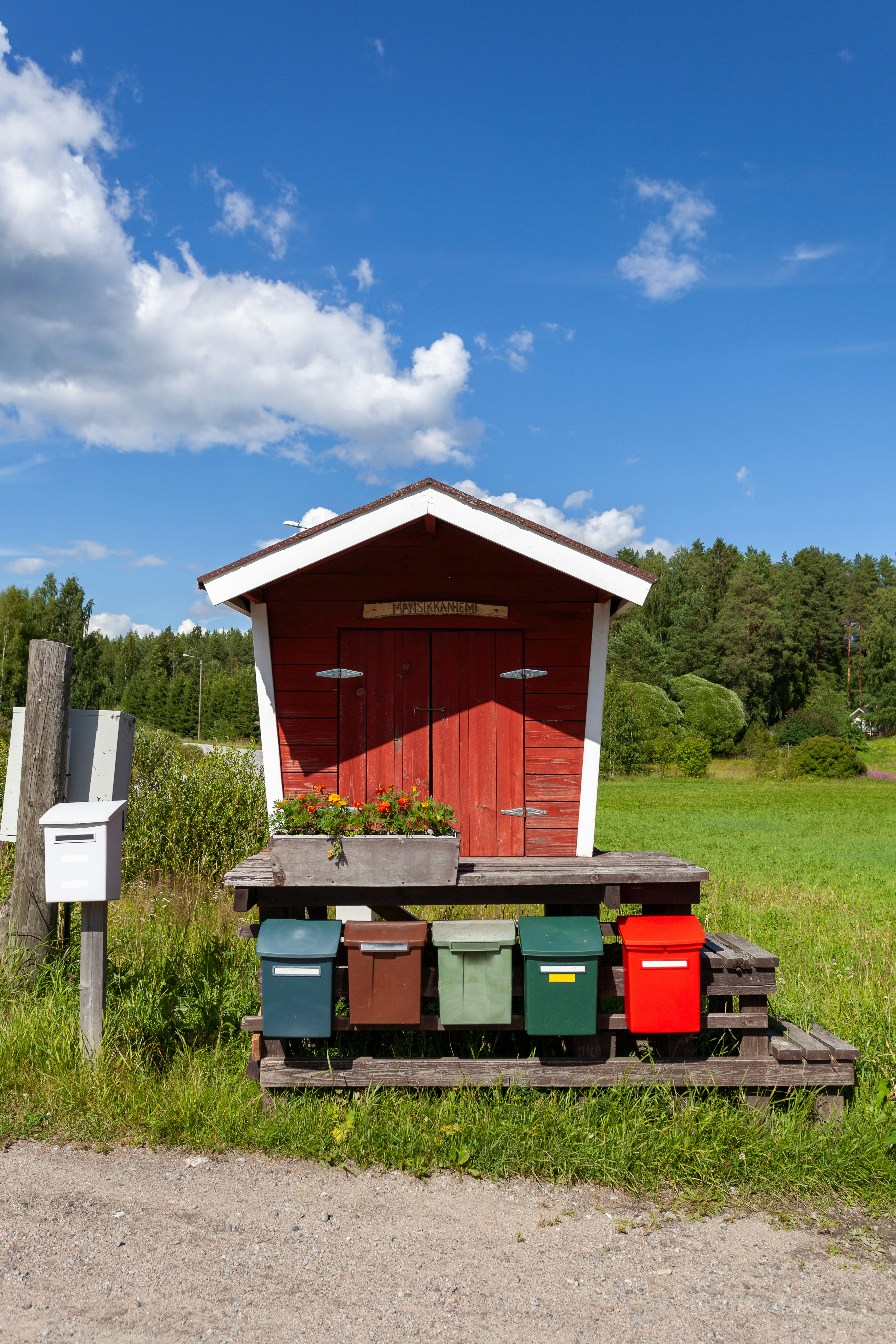A red shed sitting on top of a lush green field