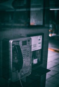 An old fashioned pay phone on the side of the street