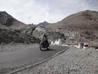 A man riding a motorcycle down a curvy road