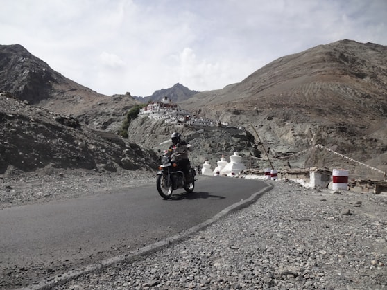 A man riding a motorcycle down a curvy road