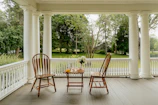 Two chairs and a table on a porch