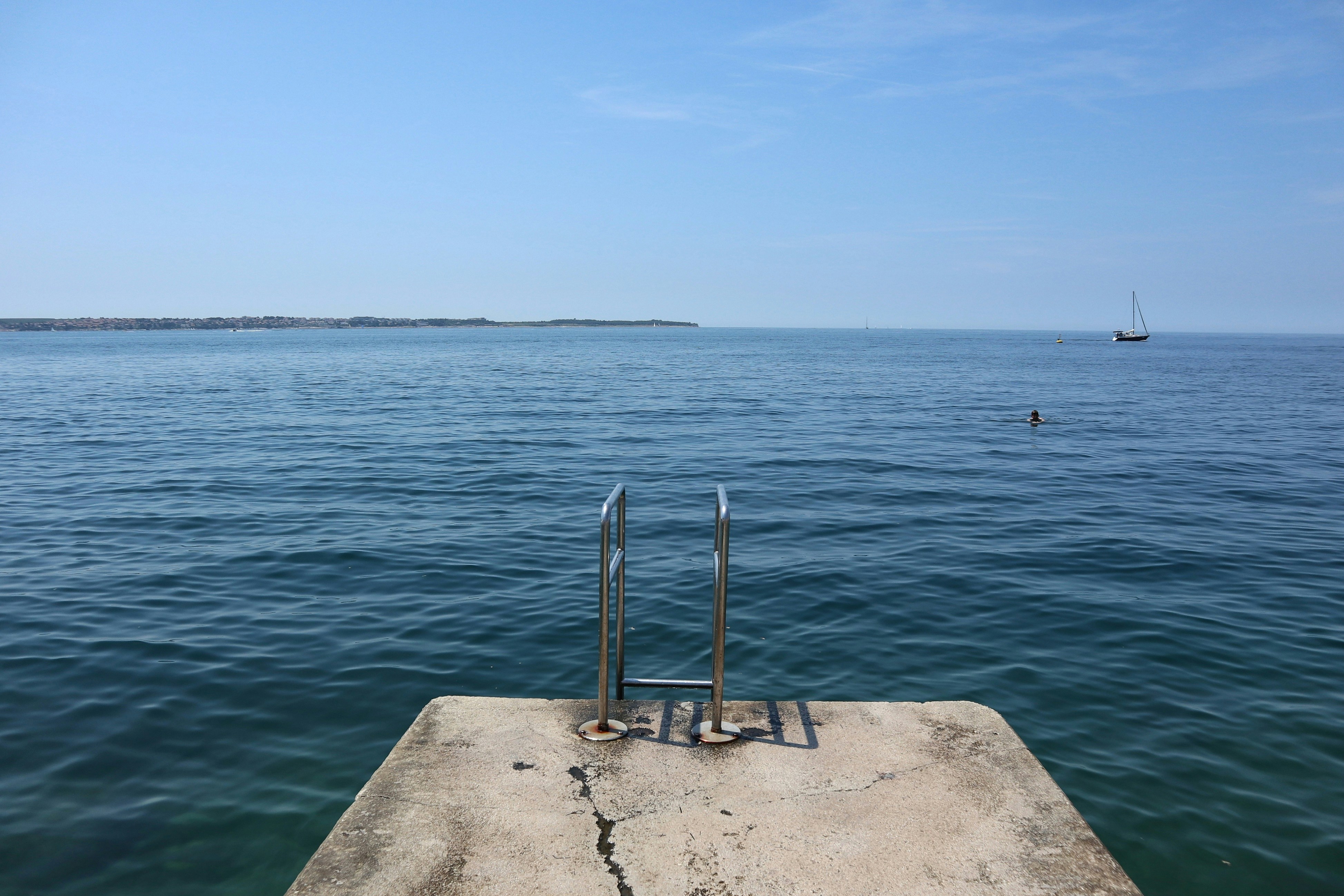 A concrete dock in the middle of a body of water