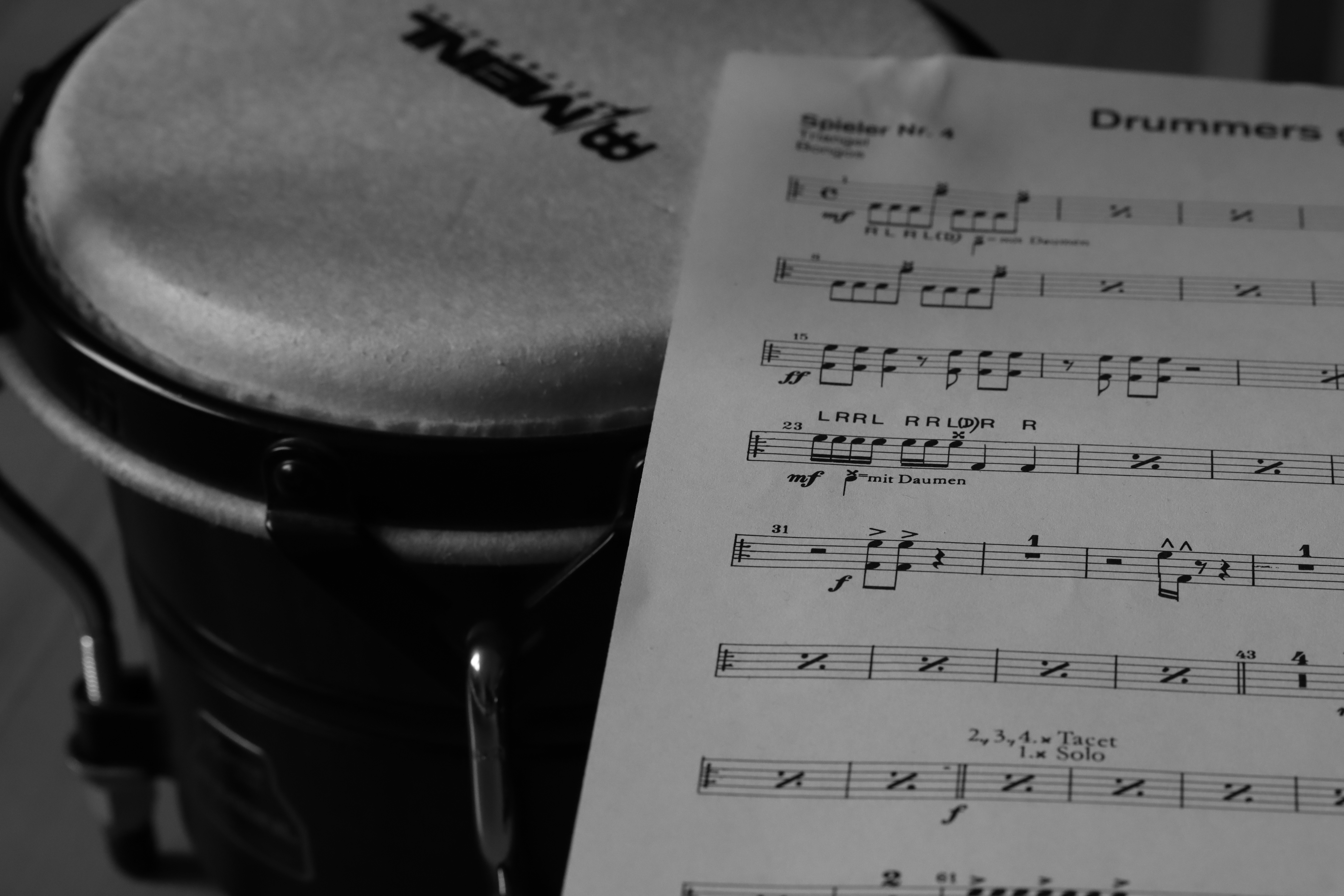 A sheet of music sitting on top of a drum