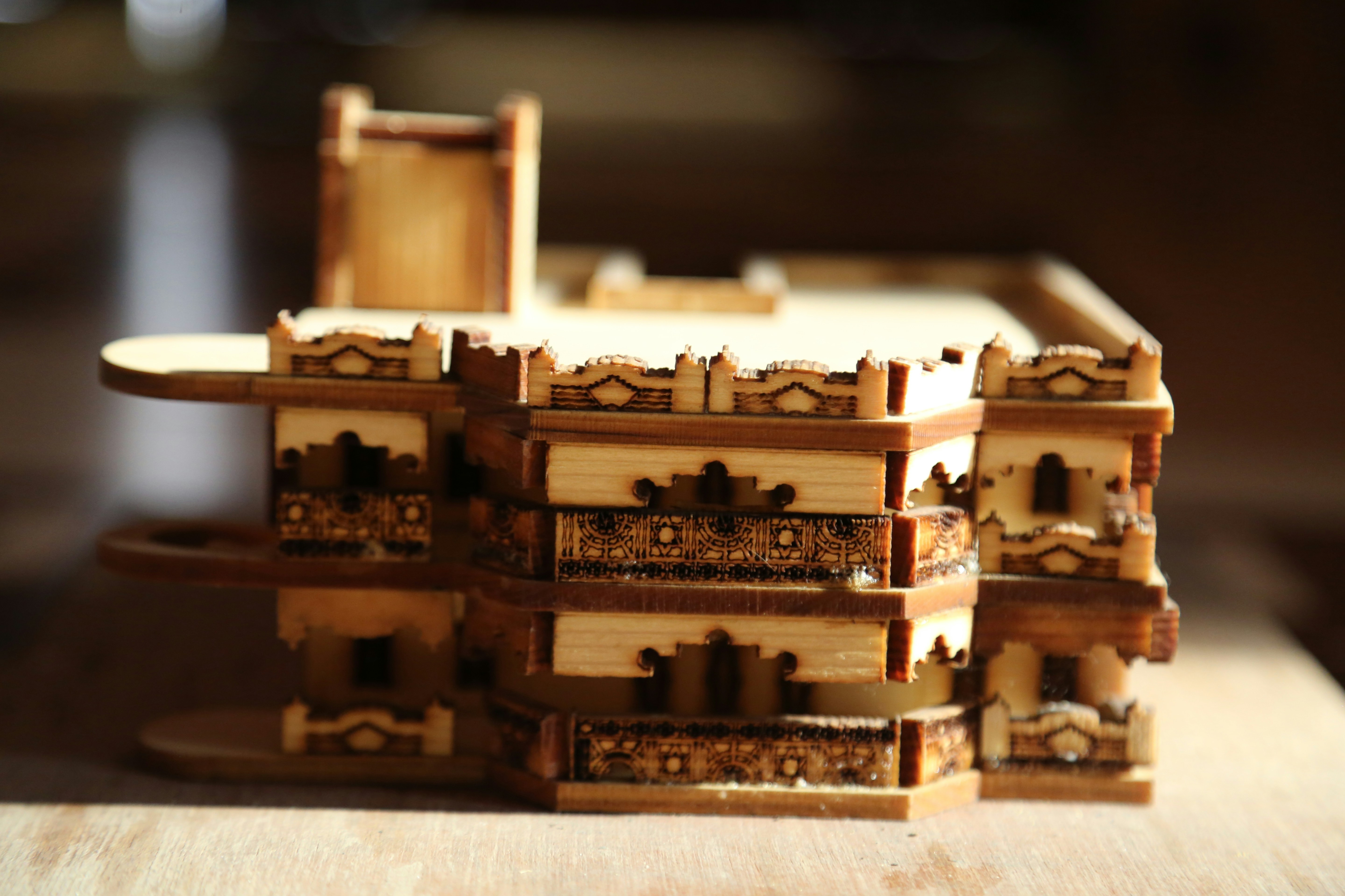 A stack of wooden boxes sitting on top of a wooden table