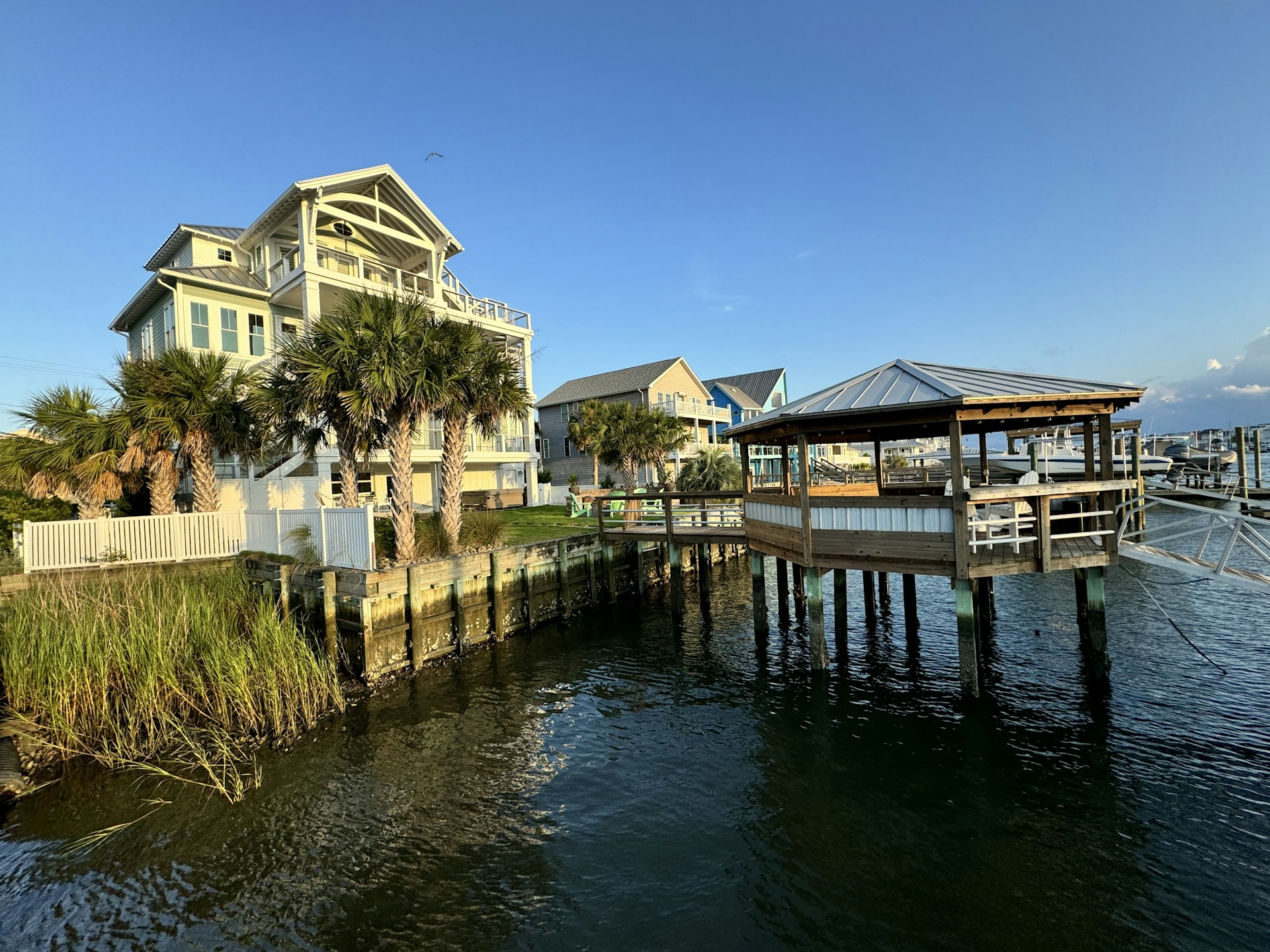 A house on the water with a dock in front of it