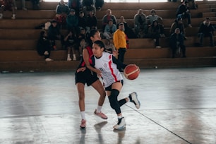 A group of people playing a game of basketball