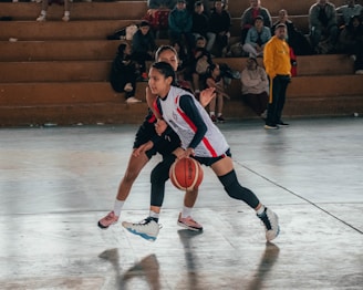A couple of men playing a game of basketball
