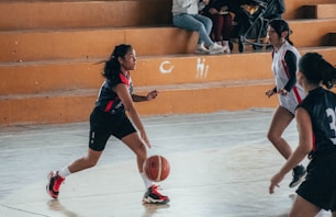 A group of women playing a game of basketball
