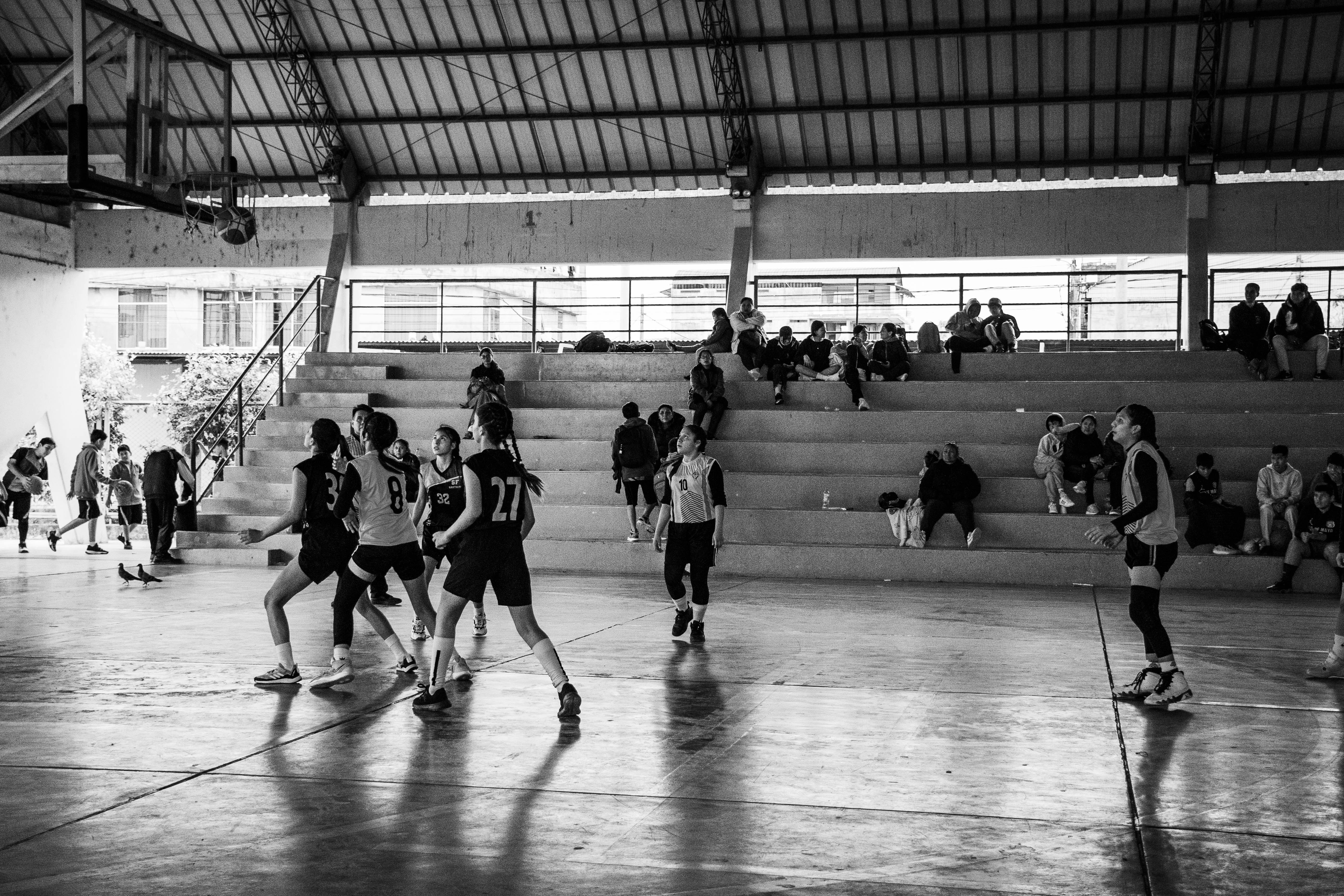 A group of young men playing a game of basketball