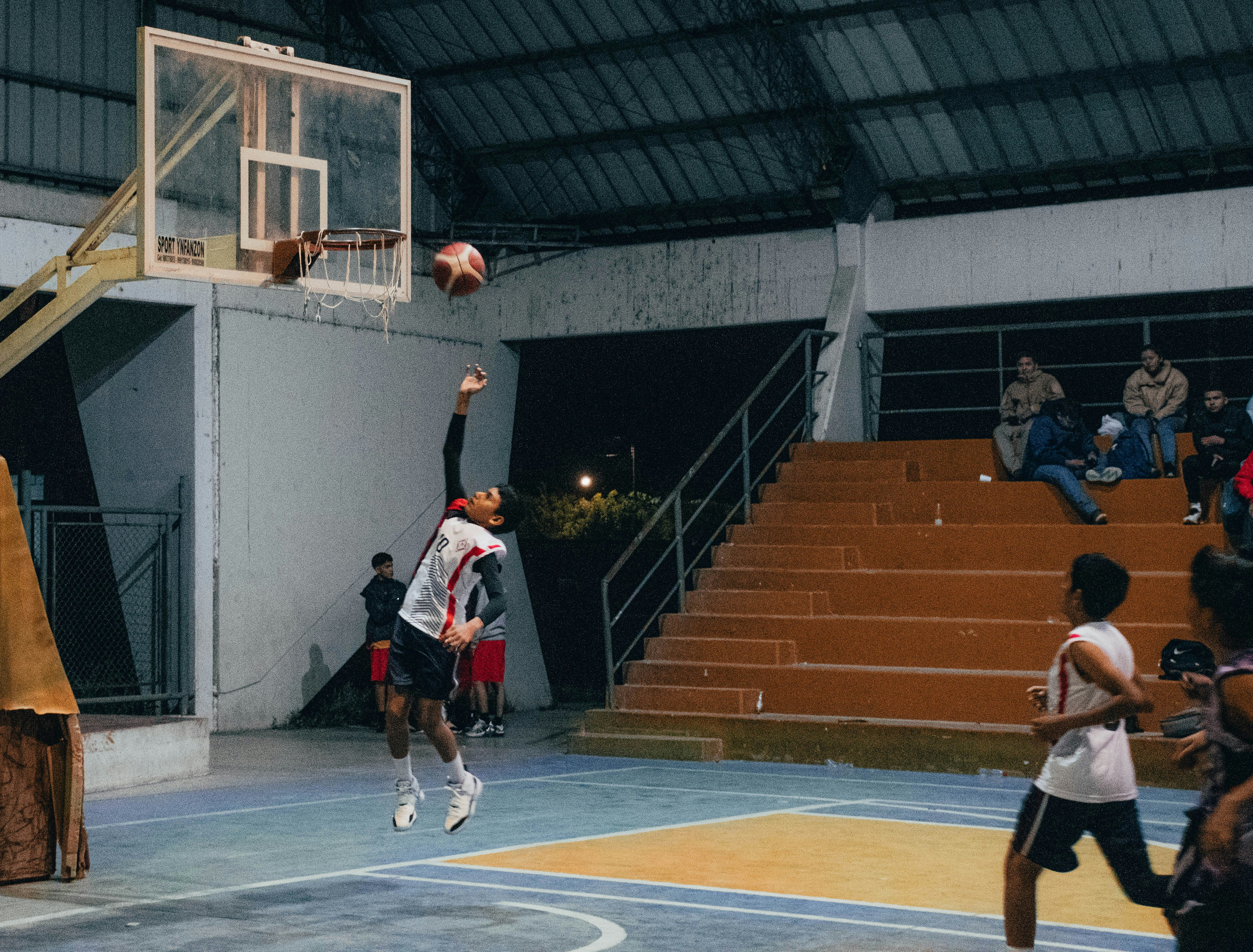 A group of young men playing a game of basketball
