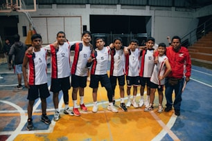 A group of young men standing on top of a basketball court
