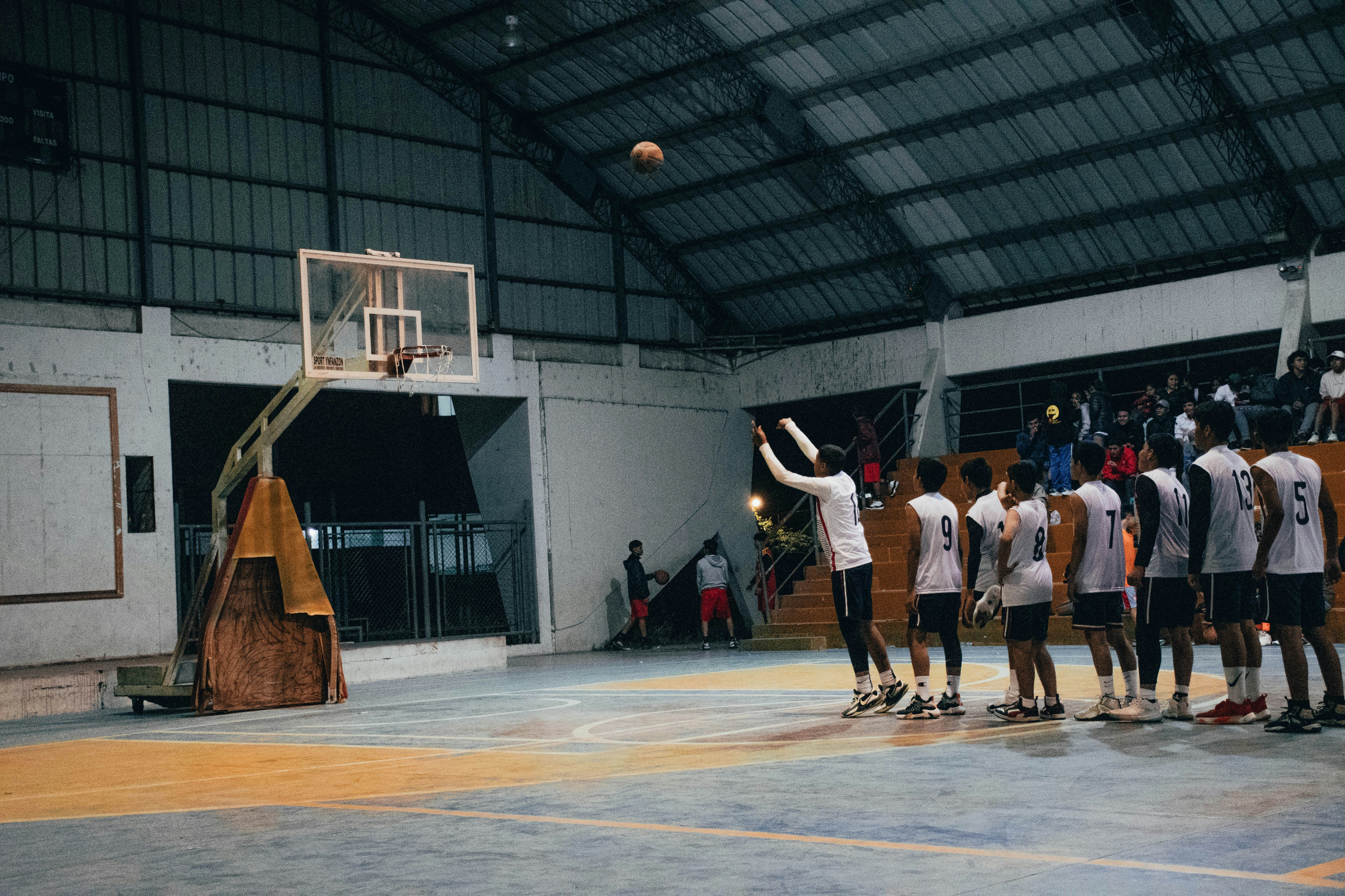 A group of young men playing a game of basketball