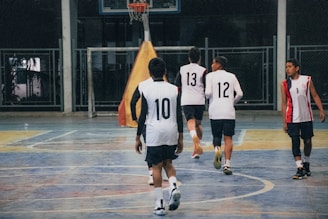 A group of young men playing a game of basketball