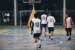 A group of young men playing a game of basketball