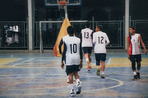 A group of young men playing a game of basketball
