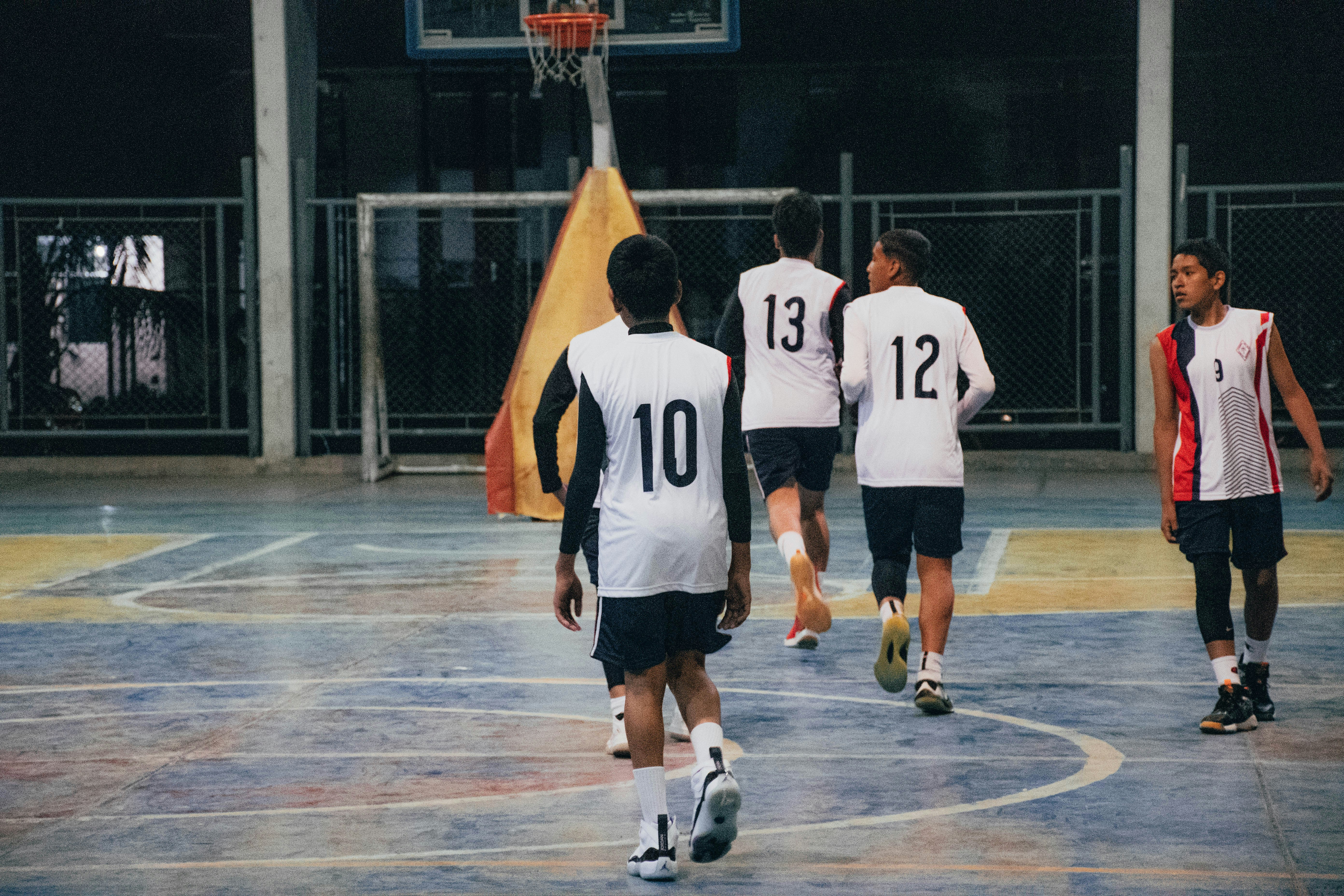 A group of young men playing a game of basketball