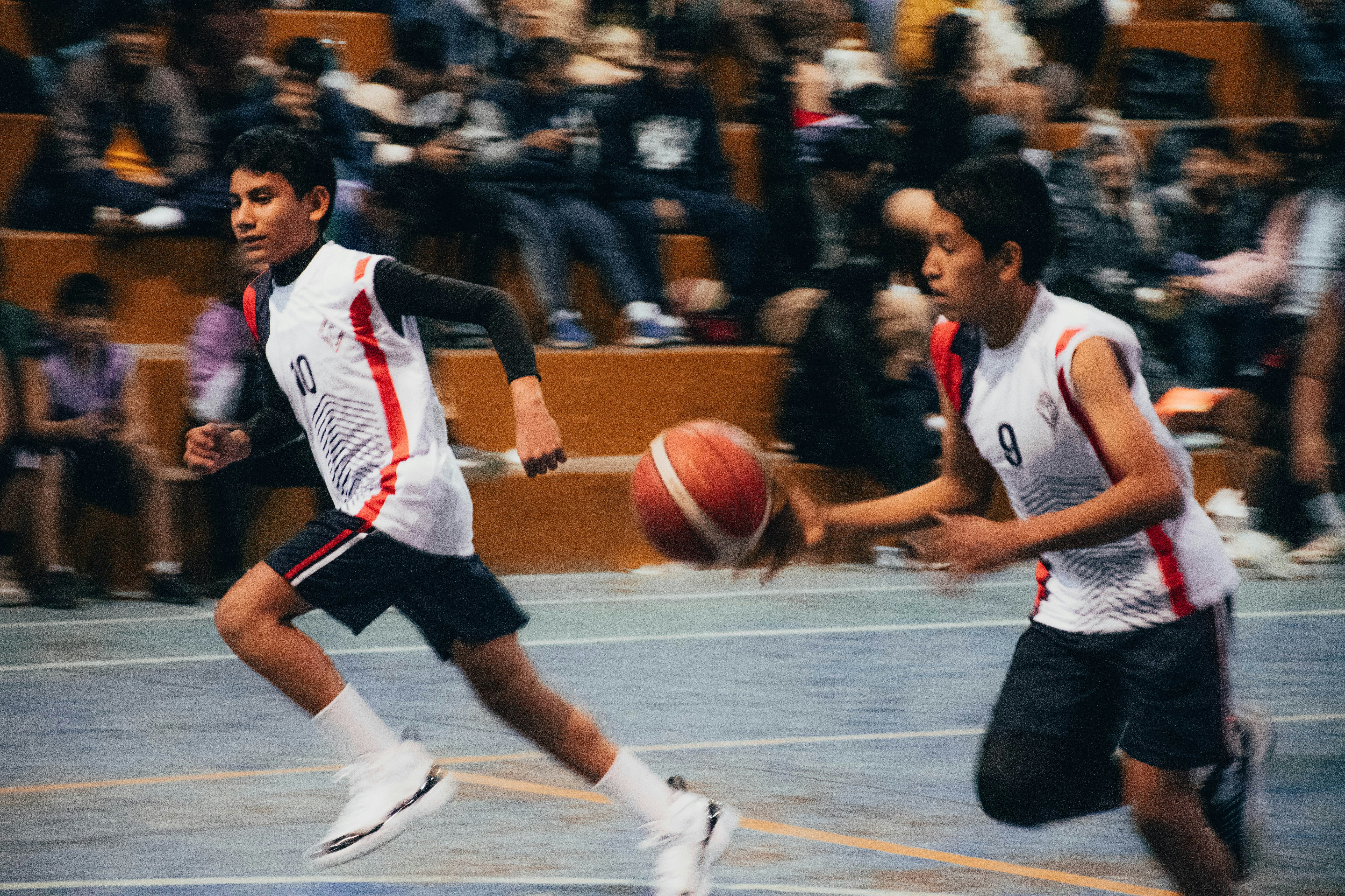A group of men playing a game of basketball