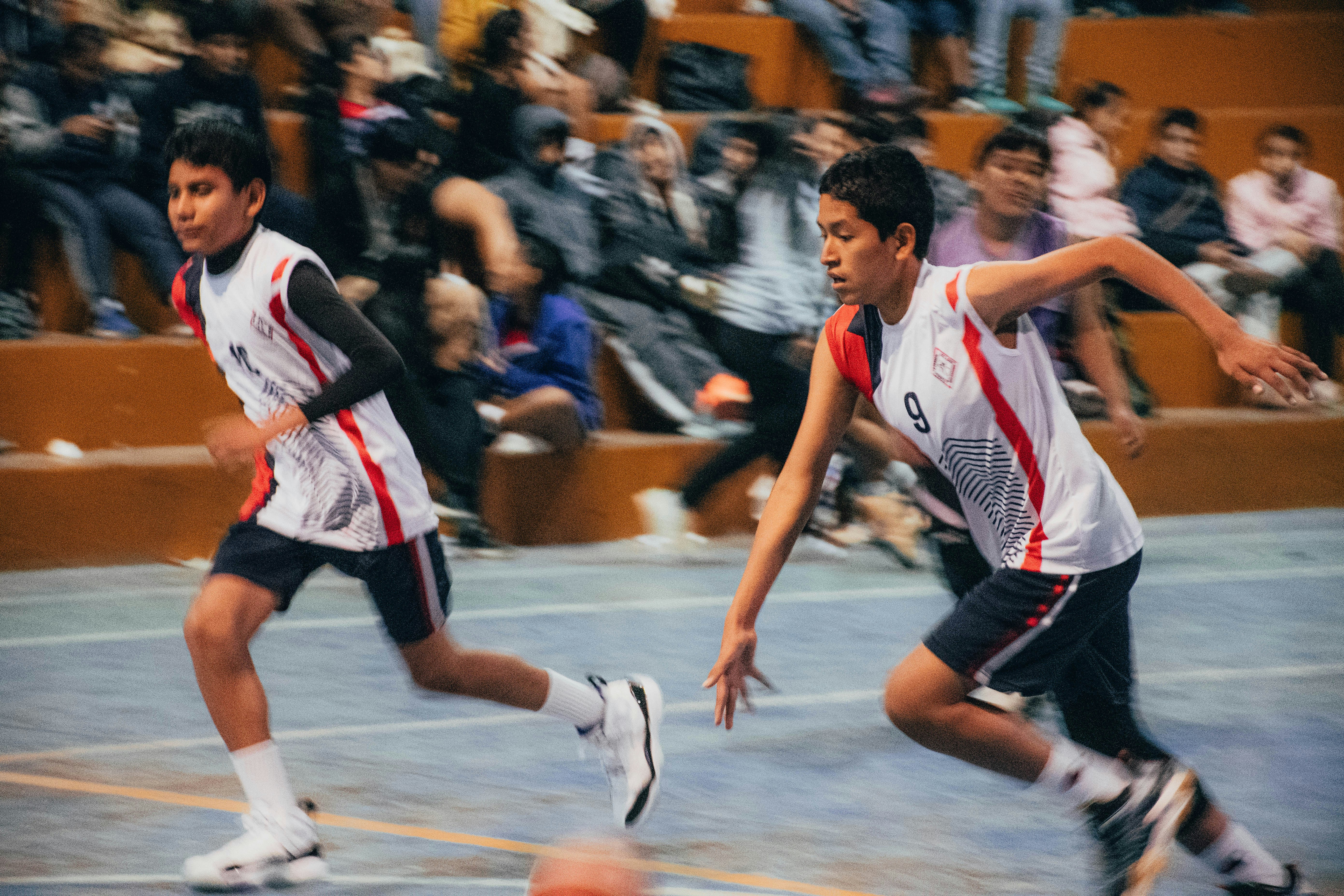 A group of young men playing a game of basketball
