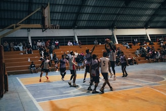 A group of young men playing a game of basketball