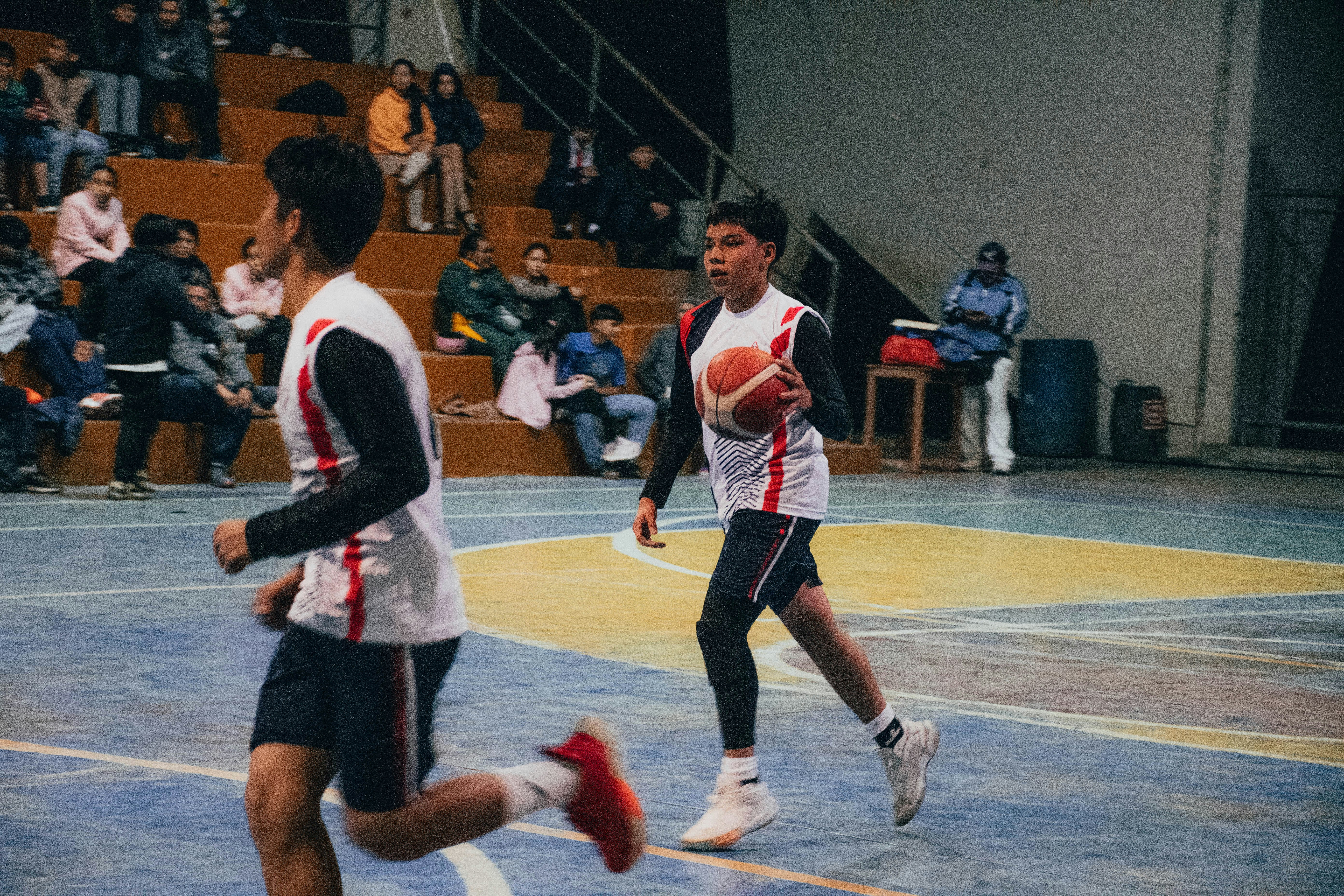 A group of young men playing a game of basketball