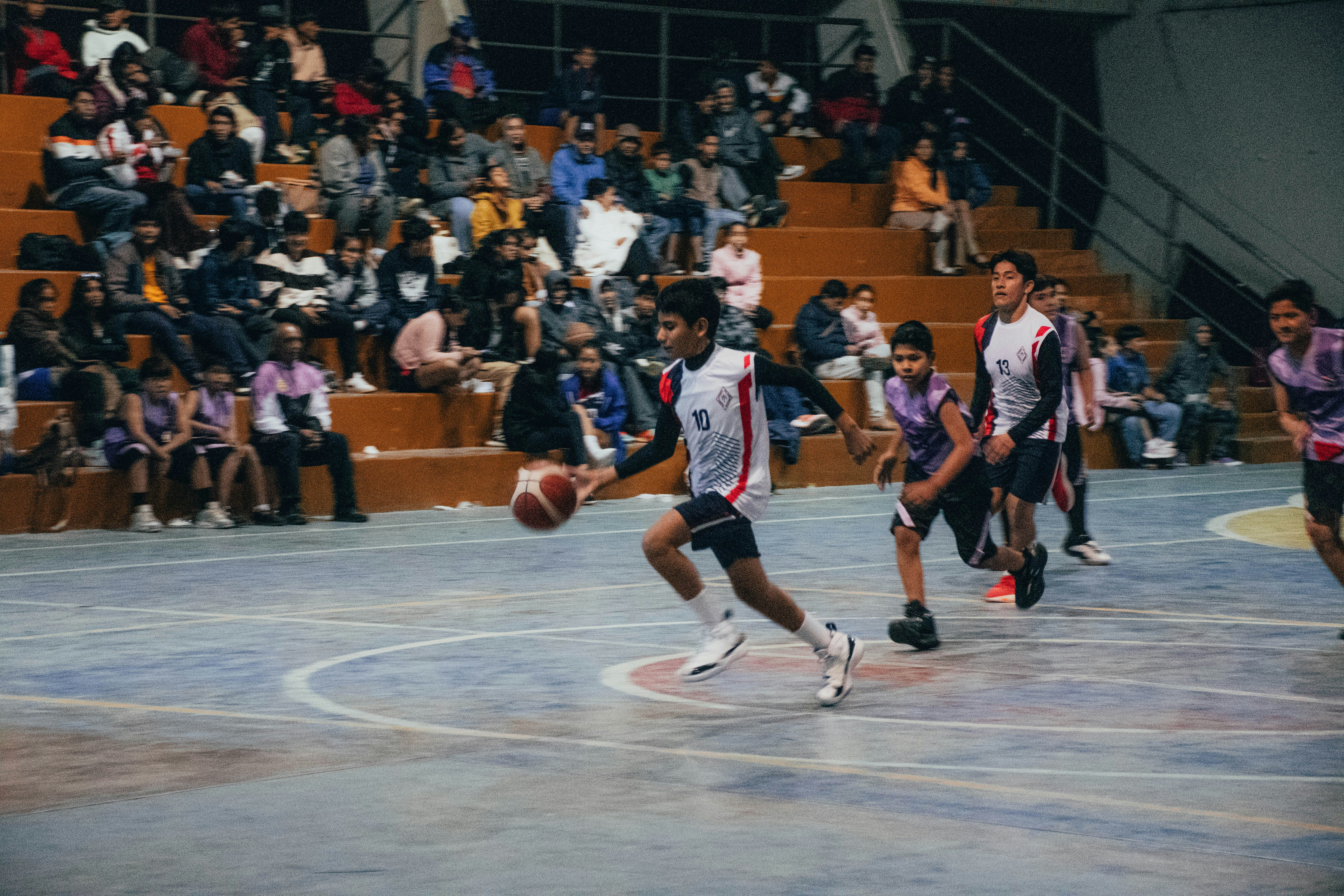 A group of men playing a game of basketball