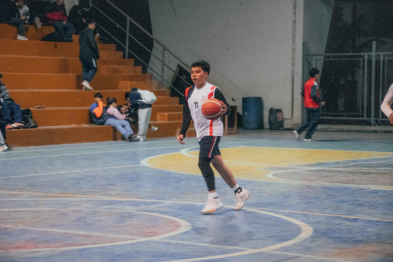 A basketball on the floor of a gym court