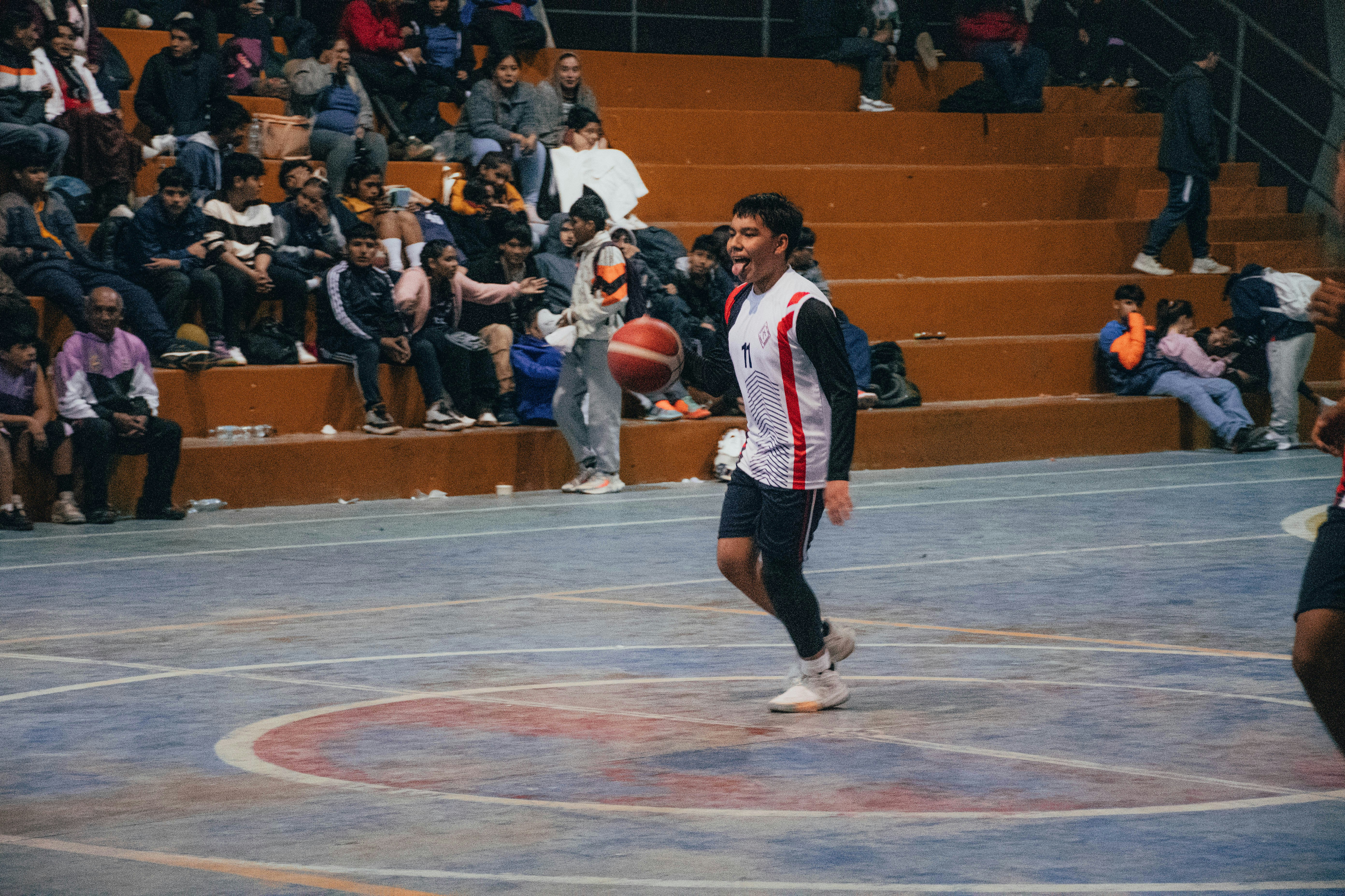 A group of men playing a game of basketball
