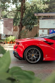 A red sports car parked in front of a gas station