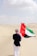 A man holding a flag in the desert