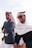 A couple of men standing next to each other on a beach