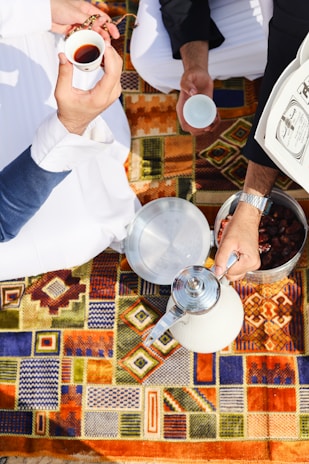 A group of people sitting around a table with food