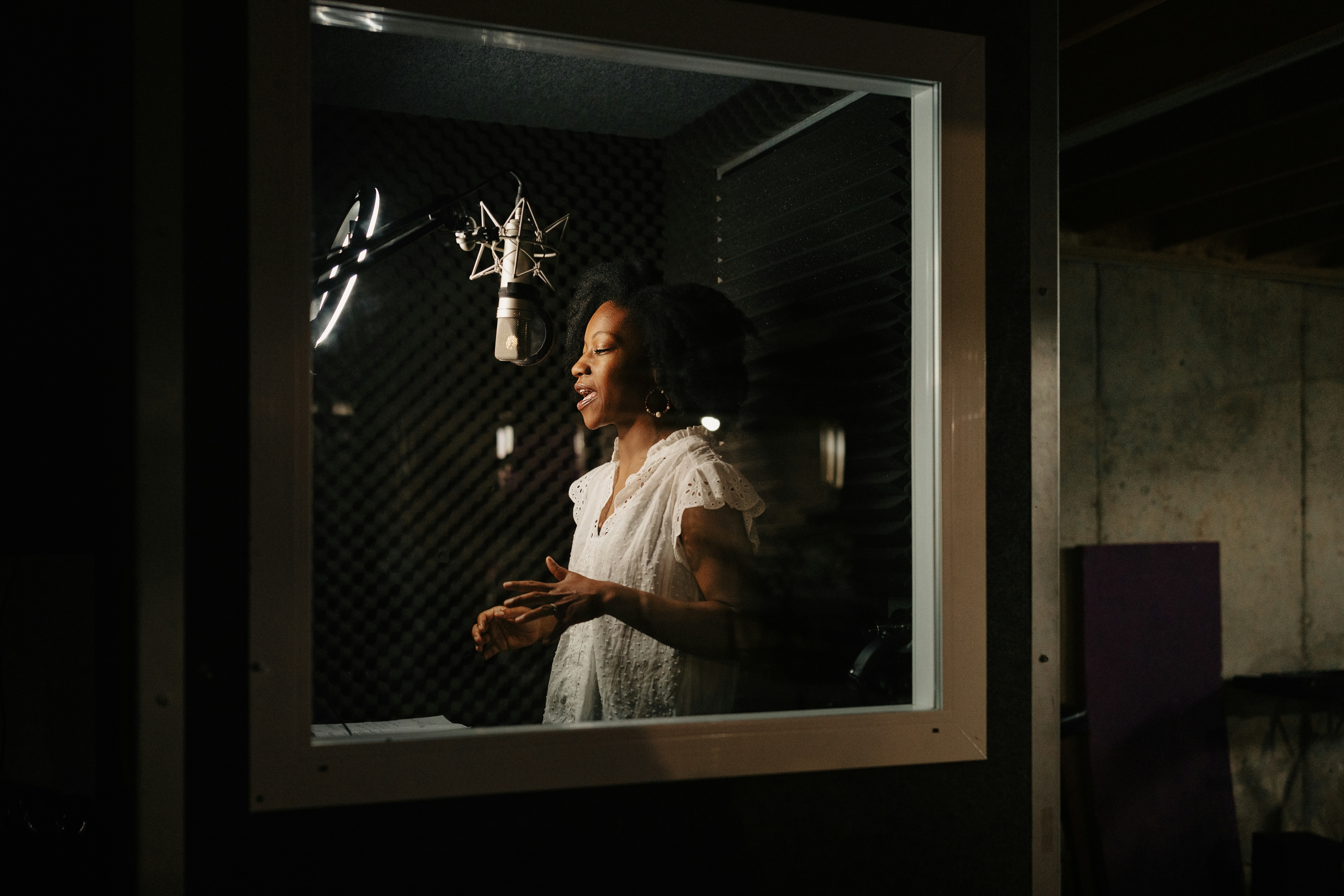 A woman standing in front of a mirror in a dark room
