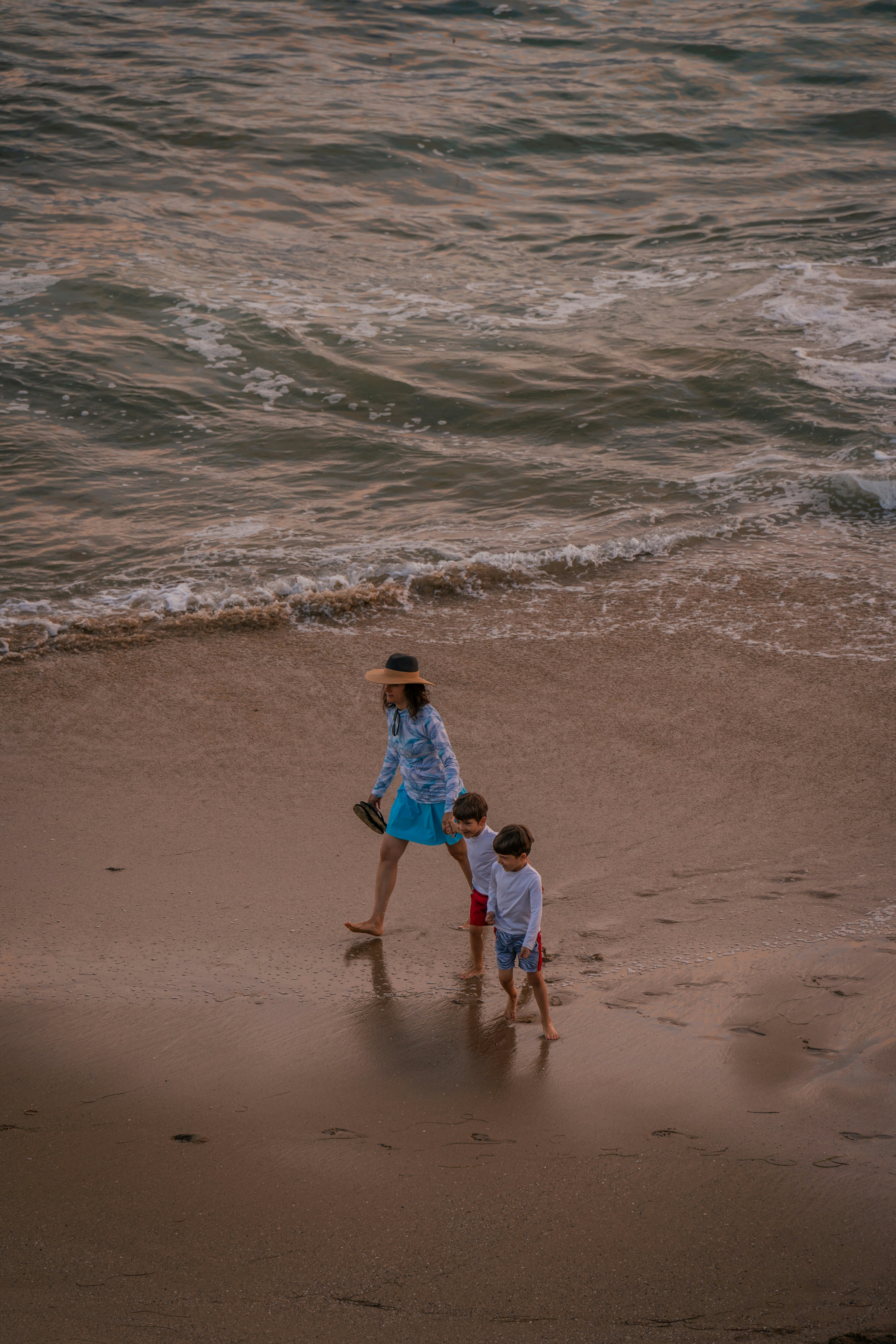 mom on the beach with 2 boys