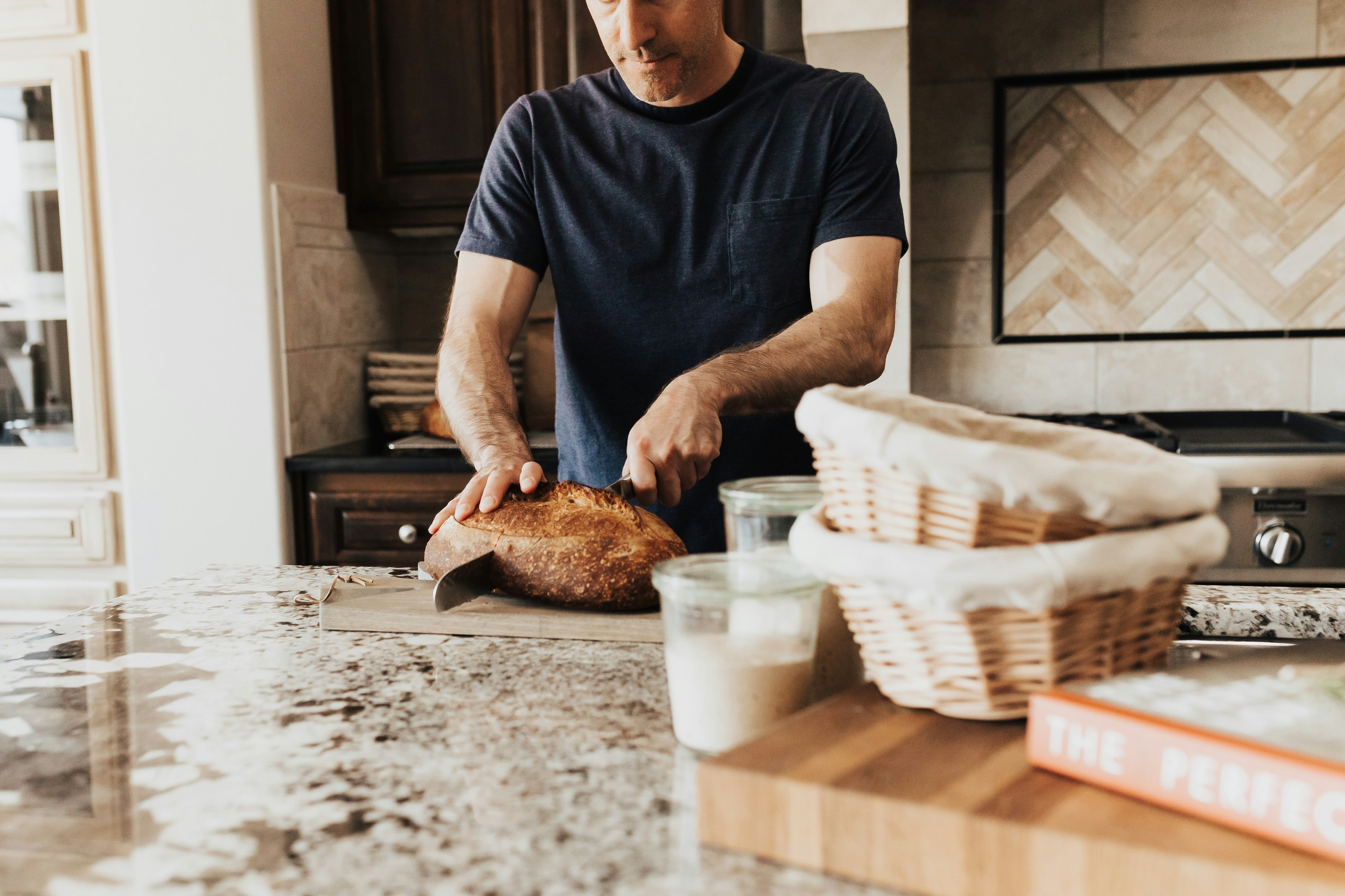 A man standing in a kitchen preparing food