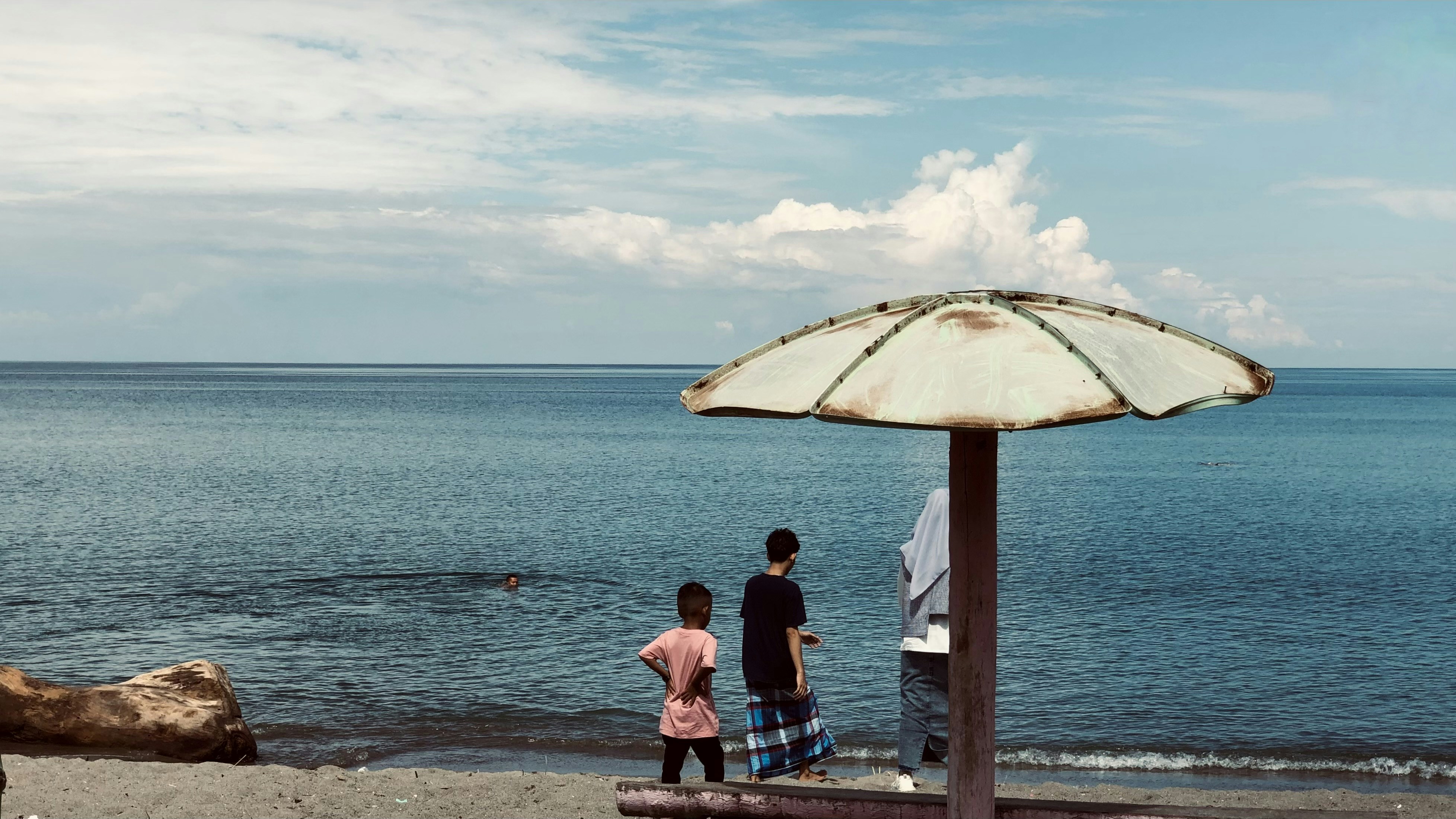 A couple of people that are standing under an umbrella