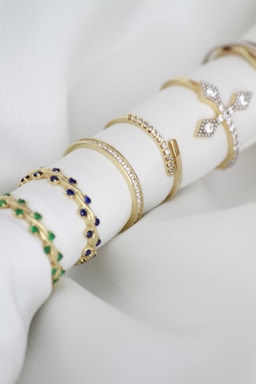 A stack of napkin rings sitting on top of a white napkin