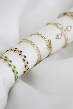 A stack of napkin rings sitting on top of a white napkin