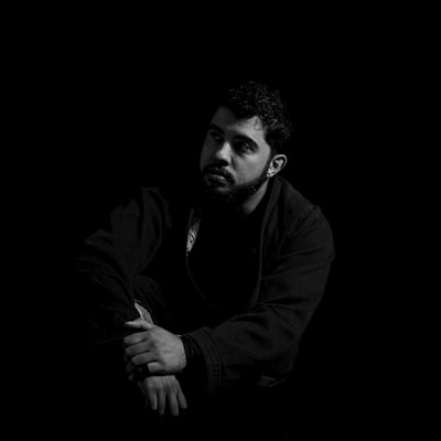 A black and white photo of a man in the dark